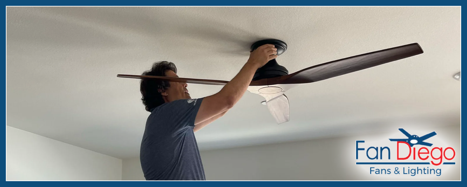 A Fan Diego electrician installing a decorative ceiling fan.